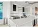 Modern cafe area featuring sleek countertops, stainless steel appliances, and contemporary design at 10367 Abaco Falls Dr, Englewood, FL 34223