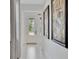 Bright entryway featuring a decorative glass door, neutral tile flooring, and artwork on the walls at 10367 Abaco Falls Dr, Englewood, FL 34223