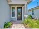 Close-up of a front door with a decorative window and brick walkway at 10367 Abaco Falls Dr, Englewood, FL 34223