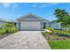 Beautiful one-story home with a brick driveway, two-car garage, and well-maintained landscaping at 10367 Abaco Falls Dr, Englewood, FL 34223