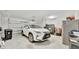 Spacious two car garage with white SUV, refrigerator and ample storage space at 10367 Abaco Falls Dr, Englewood, FL 34223