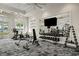 Modern fitness center with cardio machines, free weights, mirrors, and inspiring views at 10367 Abaco Falls Dr, Englewood, FL 34223