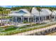 Exterior of High Tide Bar & Grill with outdoor dining, lush landscaping, and pedestrian bridge at 10367 Abaco Falls Dr, Englewood, FL 34223