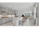 Open concept kitchen with a large island, gray cabinets, and stainless steel appliances at 10367 Abaco Falls Dr, Englewood, FL 34223