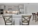 Modern kitchen with gray cabinets, stainless steel appliances, and a center island with seating at 10367 Abaco Falls Dr, Englewood, FL 34223