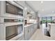 Bright, modern kitchen with stainless steel appliances, quartz countertops, and ample cabinet space at 10367 Abaco Falls Dr, Englewood, FL 34223
