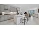 Spacious kitchen with an island, stainless steel appliances, and gray cabinets at 10367 Abaco Falls Dr, Englewood, FL 34223