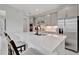 Modern kitchen with gray cabinets, stainless steel appliances, and a center island with seating for casual dining at 10367 Abaco Falls Dr, Englewood, FL 34223