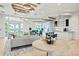 An open lobby with a seating area, kitchen, and large glass doors to the outside at 10367 Abaco Falls Dr, Englewood, FL 34223