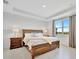 Comfortable main bedroom featuring natural light, tray ceiling and tasteful decor at 10367 Abaco Falls Dr, Englewood, FL 34223
