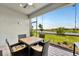 Screened in patio for outdoor relaxation, with dining set and tranquil view of the lake at 10367 Abaco Falls Dr, Englewood, FL 34223