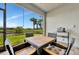 Charming outdoor patio with dining set and tranquil view of the community lake at 10367 Abaco Falls Dr, Englewood, FL 34223