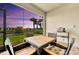 Enjoy outdoor dining on this screened patio with seating for four and a grill, offering serene views at 10367 Abaco Falls Dr, Englewood, FL 34223