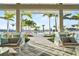 View of sparkling community pool framed by manicured landscaping, palm trees, and comfortable lounge furniture at 10367 Abaco Falls Dr, Englewood, FL 34223