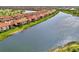 Beautiful aerial view of homes along a lake showcasing the community's waterfront living at 10789 Tarflower Dr # 202, Venice, FL 34293