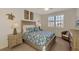Cozy bedroom featuring a comfortable bed, beach themed decor, and a bright window at 10789 Tarflower Dr # 202, Venice, FL 34293