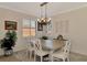 Elegant dining room featuring a wooden table, comfortable seating, and a stylish chandelier for memorable gatherings at 10789 Tarflower Dr # 202, Venice, FL 34293