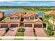 Beautiful townhome exterior featuring a tile roof, paver driveway and lush landscaping with waterfront view at 10789 Tarflower Dr # 202, Venice, FL 34293