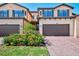 Lovely townhome exterior with brick driveway and well-maintained landscaping at 10789 Tarflower Dr # 202, Venice, FL 34293