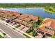 Stunning aerial view of townhomes with tile roofs, paver driveways, and lush landscaping at 10789 Tarflower Dr # 202, Venice, FL 34293