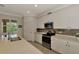 Stylish kitchen boasts stainless steel appliances, quartz countertops, and tiled backsplash at 10789 Tarflower Dr # 202, Venice, FL 34293