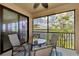 Inviting screened lanai with an outdoor table and a calming lake view at 10789 Tarflower Dr # 202, Venice, FL 34293