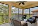 Relaxing screened lanai featuring comfortable seating and a serene lake view at 10789 Tarflower Dr # 202, Venice, FL 34293