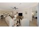 Spacious living room showcases neutral tones, a ceiling fan, and seamless flow into other rooms at 10789 Tarflower Dr # 202, Venice, FL 34293