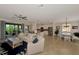 Open-concept living room with a ceiling fan, plush seating, and seamless flow to outdoor balcony at 10789 Tarflower Dr # 202, Venice, FL 34293