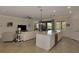 Bright living space features kitchen island seating, balcony access, and comfortable seating arrangements at 10789 Tarflower Dr # 202, Venice, FL 34293