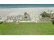 Expansive backyard featuring a lush lawn and direct access to the pristine white sand beach at 1100 Tarpon Center Dr # 503 5C, Venice, FL 34285