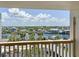 Balcony view with boats along the marina and houses with palm trees along the channel at 1100 Tarpon Center Dr # 503 5C, Venice, FL 34285