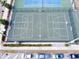 Aerial view of an outdoor basketball court with parking spots, showcasing the recreational amenities available at 1100 Tarpon Center Dr # 503 5C, Venice, FL 34285