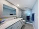 Modern bathroom features marble countertop, framed mirror, sleek glass shower with ocean view, and tiled walls at 1100 Tarpon Center Dr # 503 5C, Venice, FL 34285