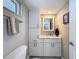 Cozy bathroom featuring marble countertop, framed mirror, tiled walls, and ample cabinet space at 1100 Tarpon Center Dr # 503 5C, Venice, FL 34285