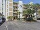 Bahia Mar condo building with mature landscaping and covered parking area at 1100 Tarpon Center Dr # 503 5C, Venice, FL 34285