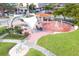 Aerial view of a community park featuring a splash fountain, picnic tables, and ample green space at 1100 Tarpon Center Dr # 503 5C, Venice, FL 34285