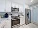 Well-equipped kitchen with stainless steel appliances and white cabinets, ideal for culinary enthusiasts at 1100 Tarpon Center Dr # 503 5C, Venice, FL 34285