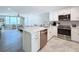 Open-concept kitchen with marble countertops and stainless appliances, perfect for entertaining and cooking at 1100 Tarpon Center Dr # 503 5C, Venice, FL 34285