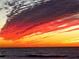 Dramatic ocean sunset featuring vibrant hues of red and yellow reflected across the water and clouds at 1100 Tarpon Center Dr # 503 5C, Venice, FL 34285