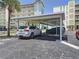 Parking lot featuring covered parking spaces at 1100 Tarpon Center Dr # 503 5C, Venice, FL 34285