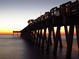 Picturesque pier at sunset, showcasing wooden beams, ocean views, and vibrant sky colors at 1100 Tarpon Center Dr # 503 5C, Venice, FL 34285