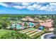 Resort-style community featuring a sparkling pool, clubhouse, and recreational green space for luxury living at 11103 Batello Dr, Venice, FL 34292