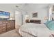 Spacious bedroom with a bed, ceiling fan, and ample closet space, with a view into the living room at 11103 Batello Dr, Venice, FL 34292