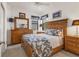 Bedroom featuring a wooden bed frame, black and white bedding, and matching wooden dressers at 11103 Batello Dr, Venice, FL 34292