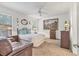 Bright bedroom with ceiling fan, a comfortable bed, and large windows offering lots of natural light at 11103 Batello Dr, Venice, FL 34292