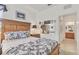 Bright bedroom featuring natural wood furniture and a black and white patterned comforter set at 11103 Batello Dr, Venice, FL 34292