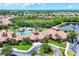 Aerial view of the Venetian Falls clubhouse, highlighting the pool, spa, and surrounding landscaping at 11103 Batello Dr, Venice, FL 34292