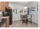Bright dining area features tile floors, a glass table with seating for four, and a large window for natural light at 11103 Batello Dr, Venice, FL 34292