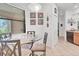 Cozy dining area with tile flooring, a glass table with seating, and natural light from a window at 11103 Batello Dr, Venice, FL 34292